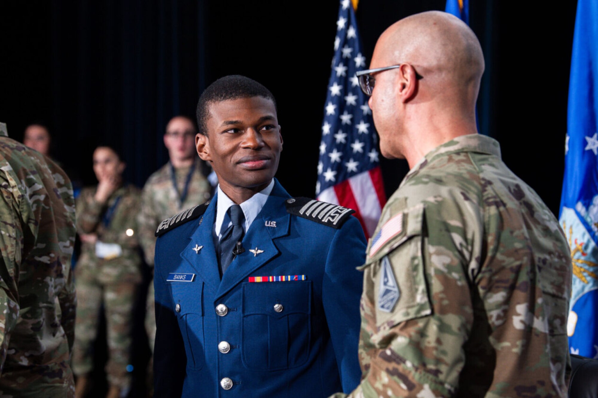 Cadet 1st Class Ruben Banks speaks with Chief Master Sgt. Of the Space Force John Bentivegna