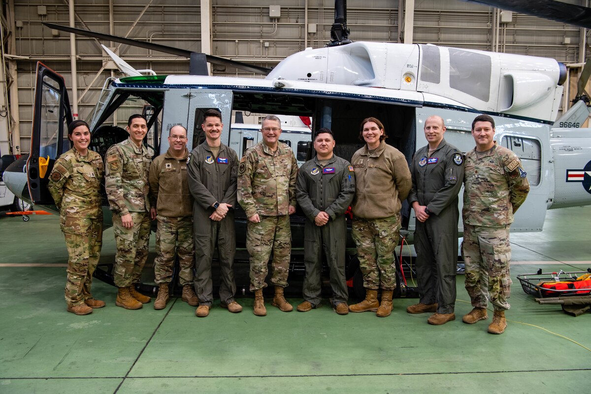 Members of the U.S. Air Force Chaplain Corps and 459th Airlift Squadron pose for a group photo in front of a UH-1N helicopter at Yokota Air Base, Japan.