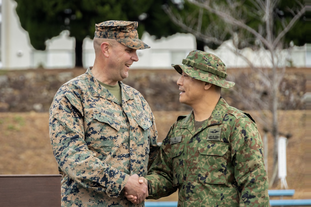 U.S. Marine Corps Col. Matthew Danner, left, the commanding officer of the 31st Marine Expeditionary Unit, and Japan Ground Self Defense Force Col. Hajime Tsuji, the commanding officer of the 2nd Amphibious Rapid Deployment Regiment, shake hands during the opening ceremony of Iron Fist 24, on Camp Ainoura, Sasebo, Japan, Feb. 25, 2024. The opening ceremony initiated training between the two armed forces. Iron Fist is an annual bilateral exercise designed to increase interoperability and strengthen the relationships between the U.S. Marine Corps, the U.S. Navy, the Japanese Ground Self Defense Force, and the Japanese Maritime Self-Defense Force. (U.S. Marine Corps photo by Lance Cpl. Peter J. Eilen)