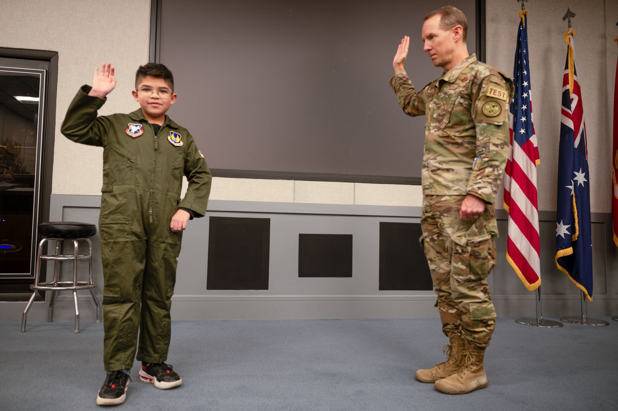 Col. Douglas Wickert, 412th Test Wing commander, "commissions" Dean Lomelin during his visit to Edwards Air Force Base, California, Jan. 31, 2024.