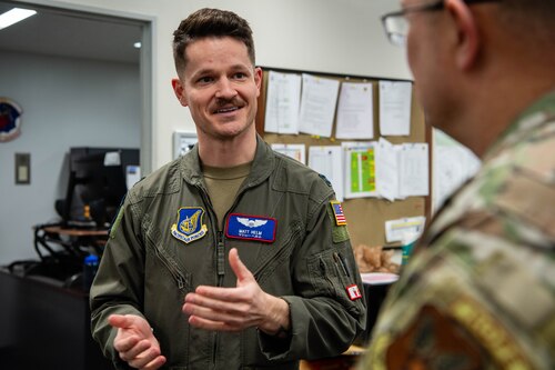 U.S. Air Force Capt. Matthew Helm, 459th Airlift Squadron UH-1N pilot, speaks to Chaplain Maj. Gen. Randall Kitchens, U.S. Air Force chief of chaplains, about the mission of the 459th Airlift Squadron at Yokota Air Base, Japan.