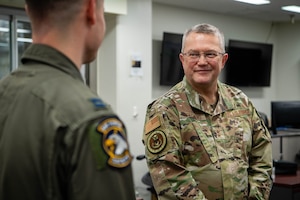 U.S. Air Force Chaplain Maj. Gen. Randall Kitchens, U.S. Air Force chief of chaplains, listens to Capt. Matthew Helm, 459th Airlift Squadron UH-1N pilot, speak about the mission of the 459th Airlift Squadron at Yokota Air Base, Japan.