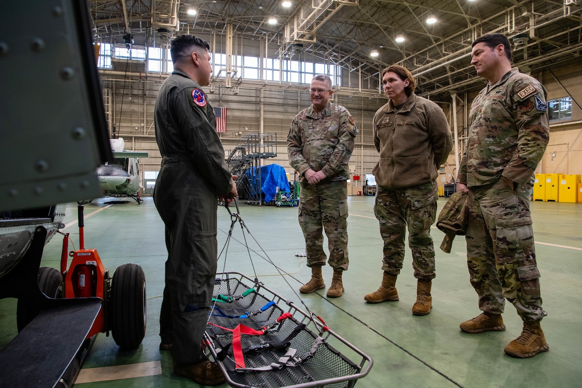 U.S. Air Force Tech. Sgt. Jeovany Vasquez, 459th Airlift Squadron non-commissioned officer in charge of tactics, speaks to Chaplain Maj. Gen. Randall Kitchens, U.S. Air Force chief of chaplains, and Chief Master Sgt. Sadie Chambers, Religious Affairs senior enlisted adviser, about aeromedical evacuation procedures at Yokota Air Base, Japan.