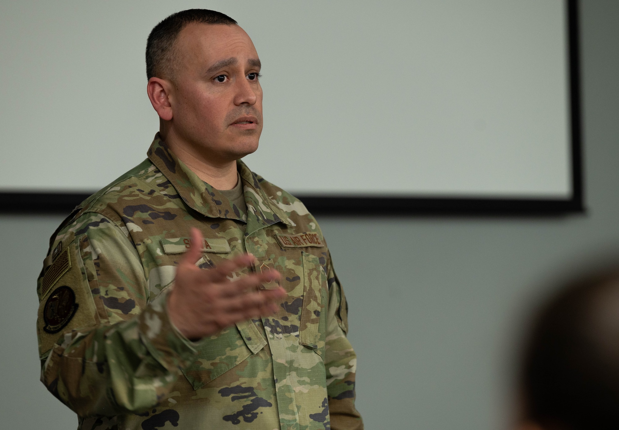 U.S. Air Force Master Sgt. John Silva, 5th Force Support Squadron first sergeant, speaks to the attendees of the First Sergeant Symposium at Minot Air Force Base, North Dakota, Feb. 22, 2024. Silva emphasized the different qualities required to be an effective first sergeant. (U.S. Air Force photo by Airman 1st Class Luis Gomez)