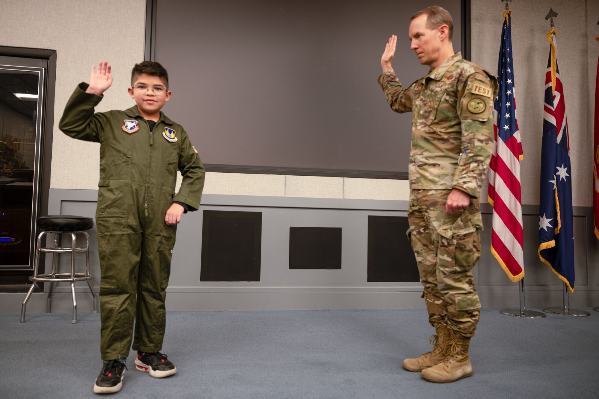 Col. Douglas Wickert, 412th Test Wing commander, "commissions" Dean Lomelin during his visit to Edwards Air Force Base, California, Jan. 31, 2024.