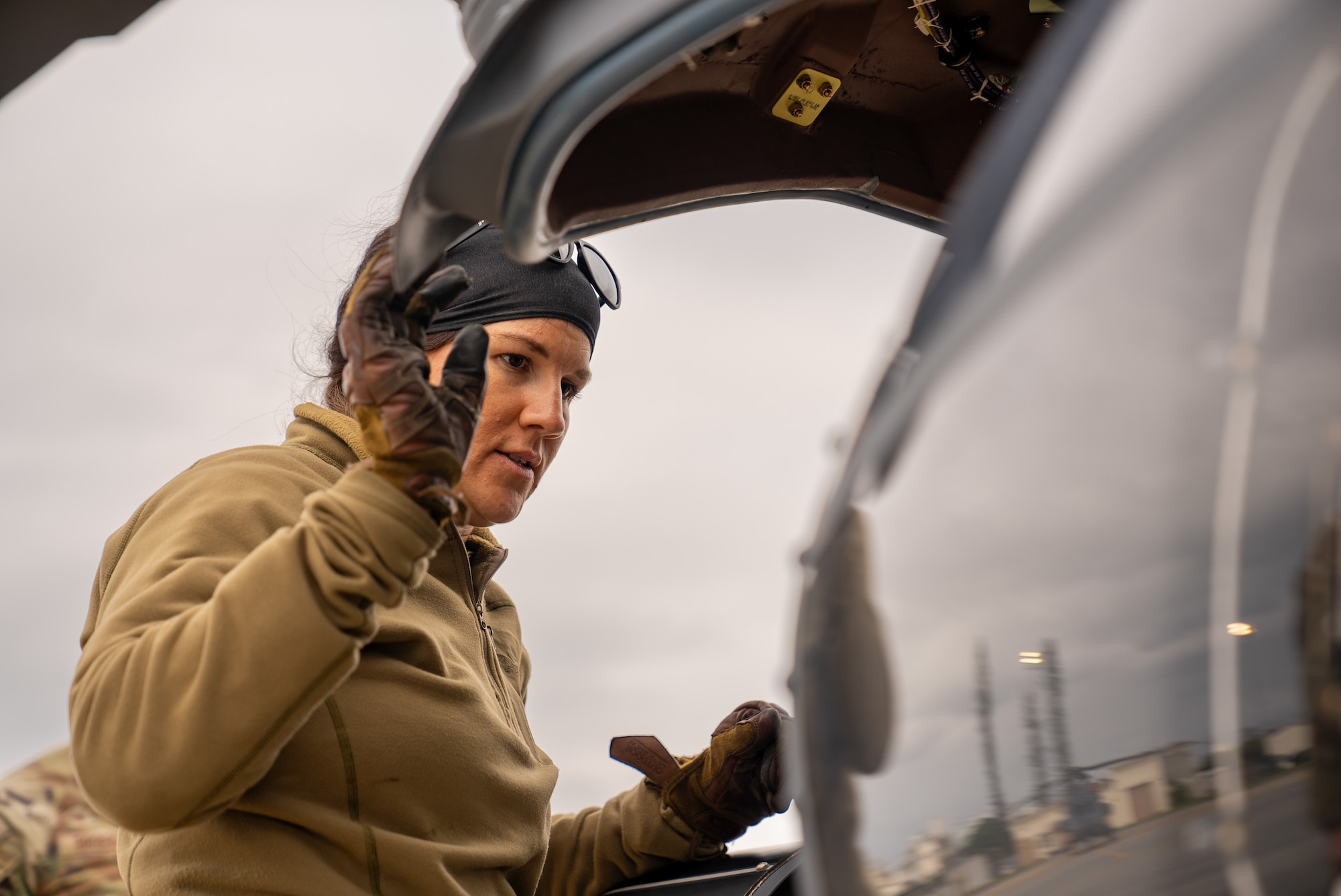A 33rd Rescue Squadron member conducting pre-flight checks
