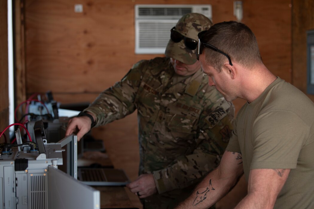 Airmen set up battle management equipment