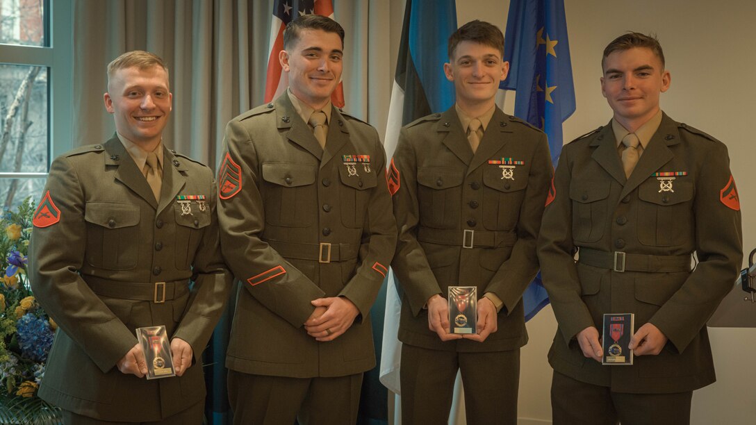 U.S. Marines with 2d Light Armored Reconnaissance Battalion, 2d Marine Division pose for a group photo during an award ceremony in Washington D.C., Feb. 23, 2024. The Marines were awarded with the Estonian Rescue Board Lifesaving Medal from the Estonian Ambassador to the United States for heroic actions by rendering medical assistance to an injured Estonian civilian. (U.S. Marine Corps photo by Cpl. Max Arellano)