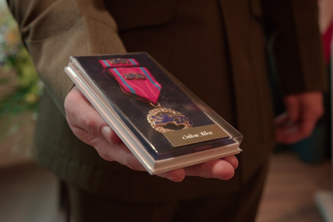 U.S. Marine Corps Lance Cpl. Colton Allen with 2d Light Armored Reconnaissance Battalion, 2d Marine Division and a Texas native, poses for a photo with the Estonian Rescue Board Lifesaving Medal in hand during an award ceremony in Washington D.C., Feb. 23, 2024.The Marines were awarded with the Estonian Rescue Board Lifesaving Medal from the Estonian Ambassador to the United States for heroic actions by rendering medical assistance to an injured Estonian civilian. (U.S. Marine Corps photo by Cpl. Max Arellano)