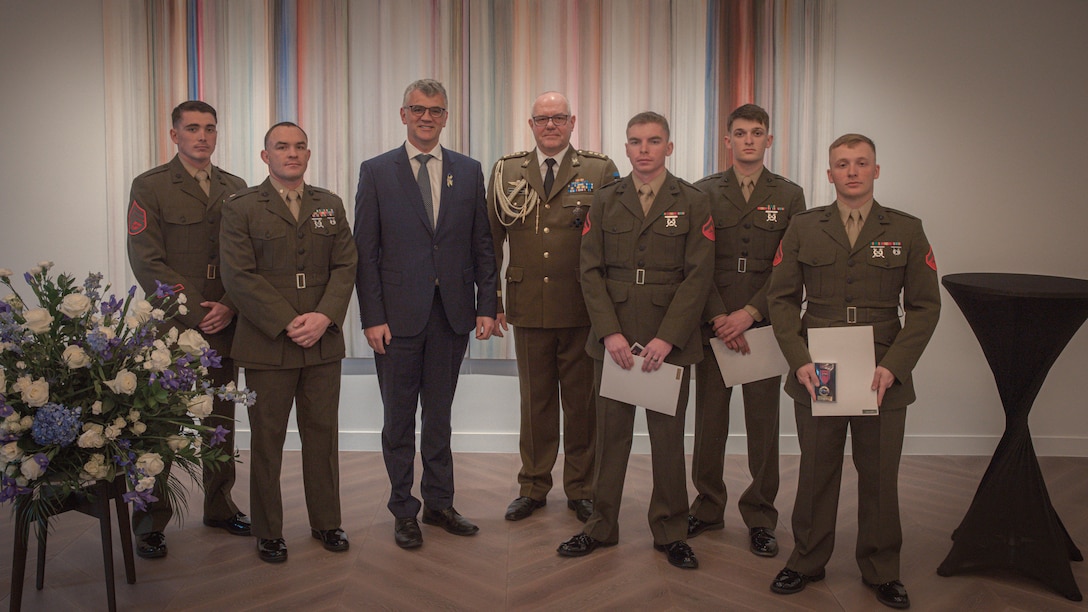 The Estonian Ambassador to the United States Mr. Kristian Prikk, 3rd from the left, and Defense Attaché Kolonel Vahur Väljamäe, center, pose for a photo with U.S. Marine Corps with 2d Light Armored Reconnaissance Battalion, 2d Marine Division who were awarded the Estonian Rescue Board Lifesaving Medal in Washington D.C., Feb. 23, 2024. The Marines were decorated with the Estonian Rescue Board Lifesaving Medal from the Estonian ambassador to the United States for heroic actions taken to render medical assistance to an injured Estonian civilian. (U.S. Marine Corps photo by Cpl. Max Arellano)