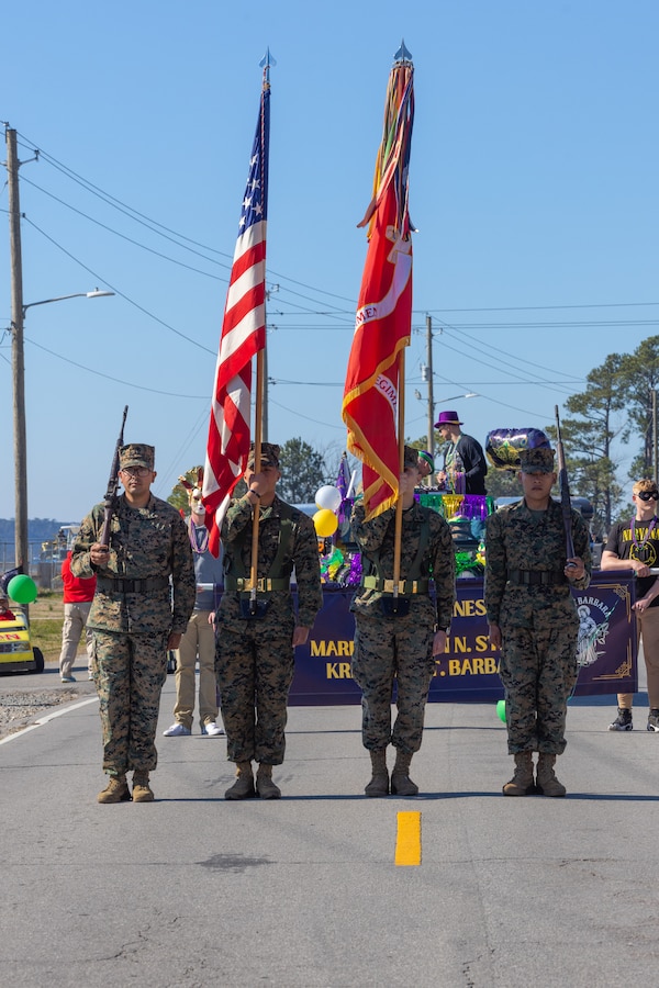 A U.S. Marine Corps color guard with 10th Marine Regiment, 2d Marine Division stage for a parade during a Mardi Gras celebration on Camp Lejeune, North Carolina, Feb. 21, 2024. The 10th Marine Regiment participated in the first Mardi Gras parade on Camp Lejeune to help build a sense of community between Marines and their families. (U.S. Marine Corps photo by Lance Cpl. Daysia McCree)