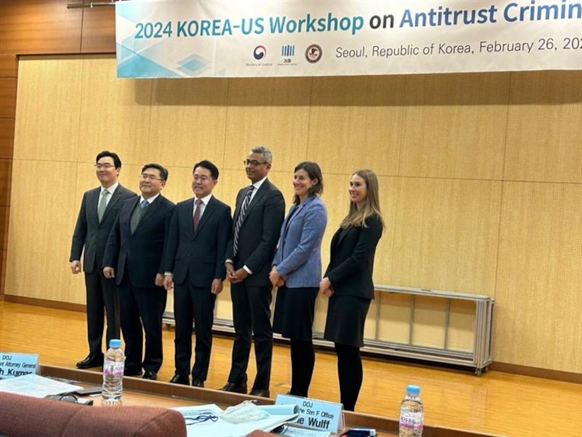 Korean and US department of justice members pose for a group photo.
