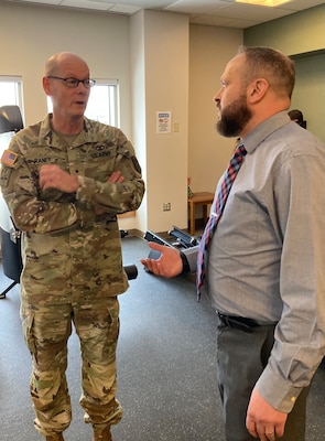 Brig. Gen. Lance Raney, Director of Defense Health Network East, speaks with Mr. Scott Ruff, Group Practice Manager, in the Physical Therapy Clinic during a visit to Fort Drum Medical Department Activity. Raney, who is also the Director for Defense Health Network East, and Poutou met with leaders and visited members of the MEDDAC at Fort Drum and leaders of the 10th Mountain Division during the 2-day visit Feb 13-14.