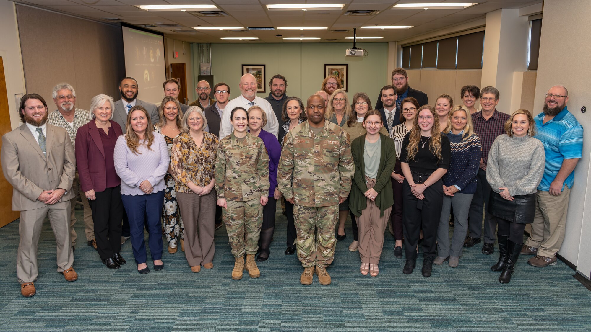 Maj. Gen. Alice Treviño, deputy assistant secretary for contracting with Office of the Assistant Secretary of the Air Force for Acquisition, Technology and Logistics, and Chief Master Sgt. Bryan Dubose, enlisted policy chief and career field manager, pause for a photo with Air Force Test Center contracting personnel for Arnold Air Force Base during their Dec. 5, 2023, visit to Arnold AFB, Tenn. Along with meeting members of the Arnold contracting team, Treviño toured several Arnold test facilities and sites on base where work is performed to support the test mission. (U.S. Air Force photo by Keith Thornburgh)