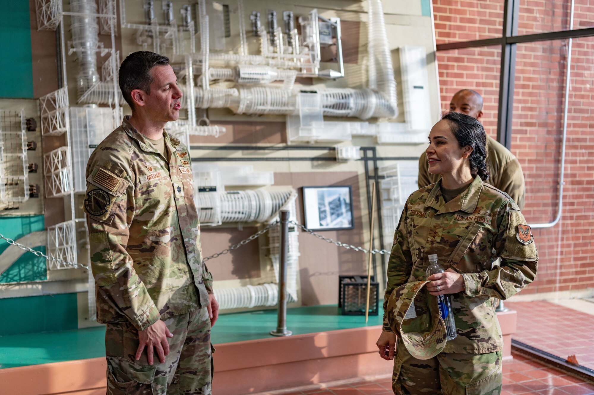 Lt. Col. James Gresham, commander of the 716th Test Squadron, left discusses the capabilities of the test squadron with Maj. Gen. Alice Treviño, deputy assistant secretary for contracting with Office of the Assistant Secretary of the Air Force for Acquisition, Technology and Logistics, during Treviño’s Dec. 5 visit to Arnold Air Force Base, Tenn. During her visit, Treviño met with members of the Arnold contracting team and toured several Arnold test facilities and sites on base where work is performed to support the test mission. (U.S. Air Force photo by Keith Thornburgh)