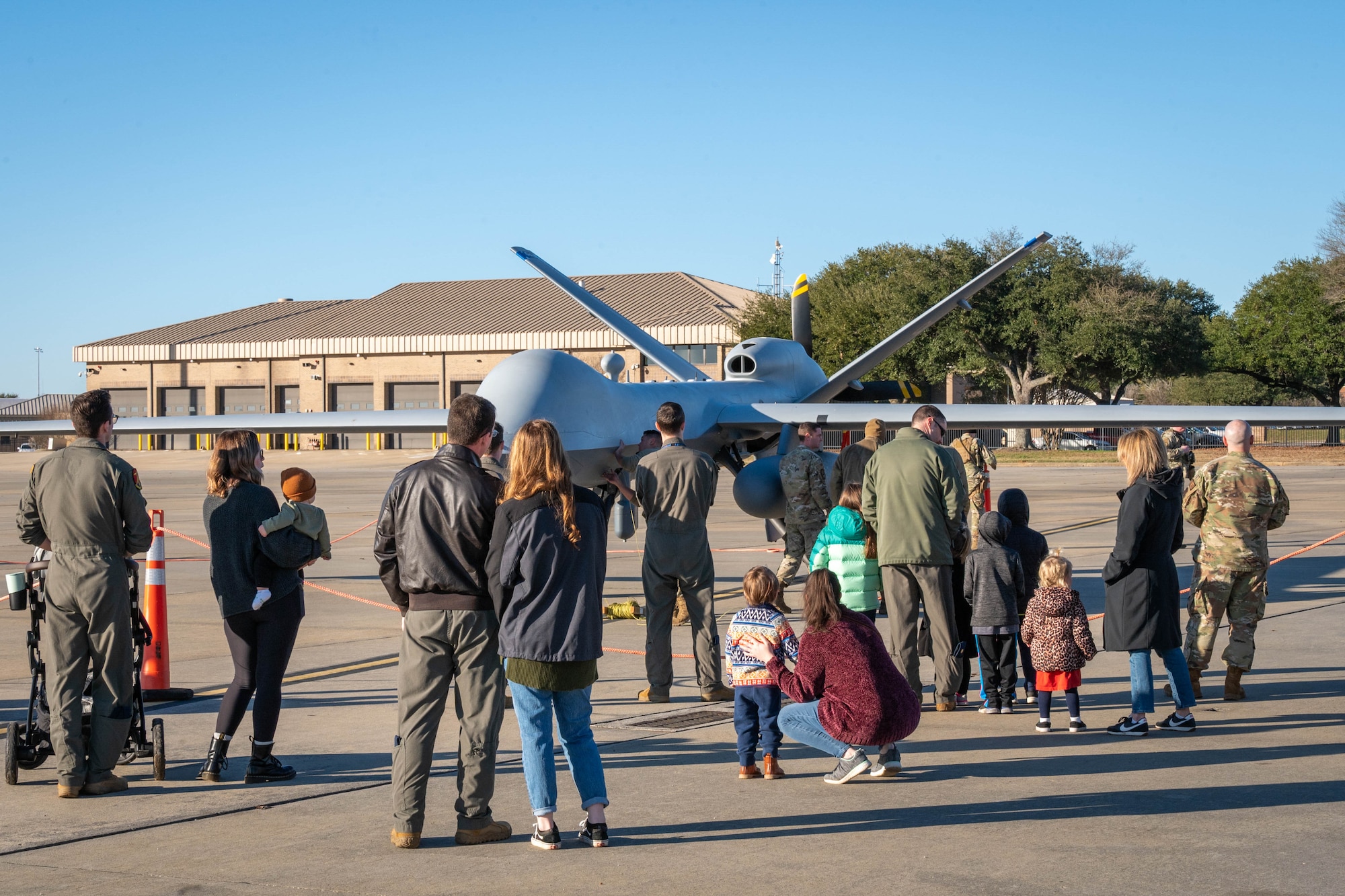 Large group of people looking at plane.