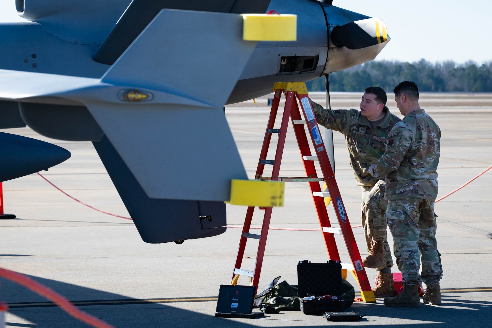 Two men working on a plane.