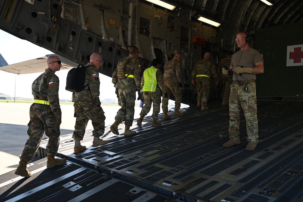 Chief Master Sgt. Michael Bolin, 433rd Aeromedical Evacuation Squadron, guides a group of Texas State Guardsmen aboard a C-17 Globemaster as part of a joint medical training event at Joint Base San Antonio-Lackland, Texas on Feb. 24, 2024.