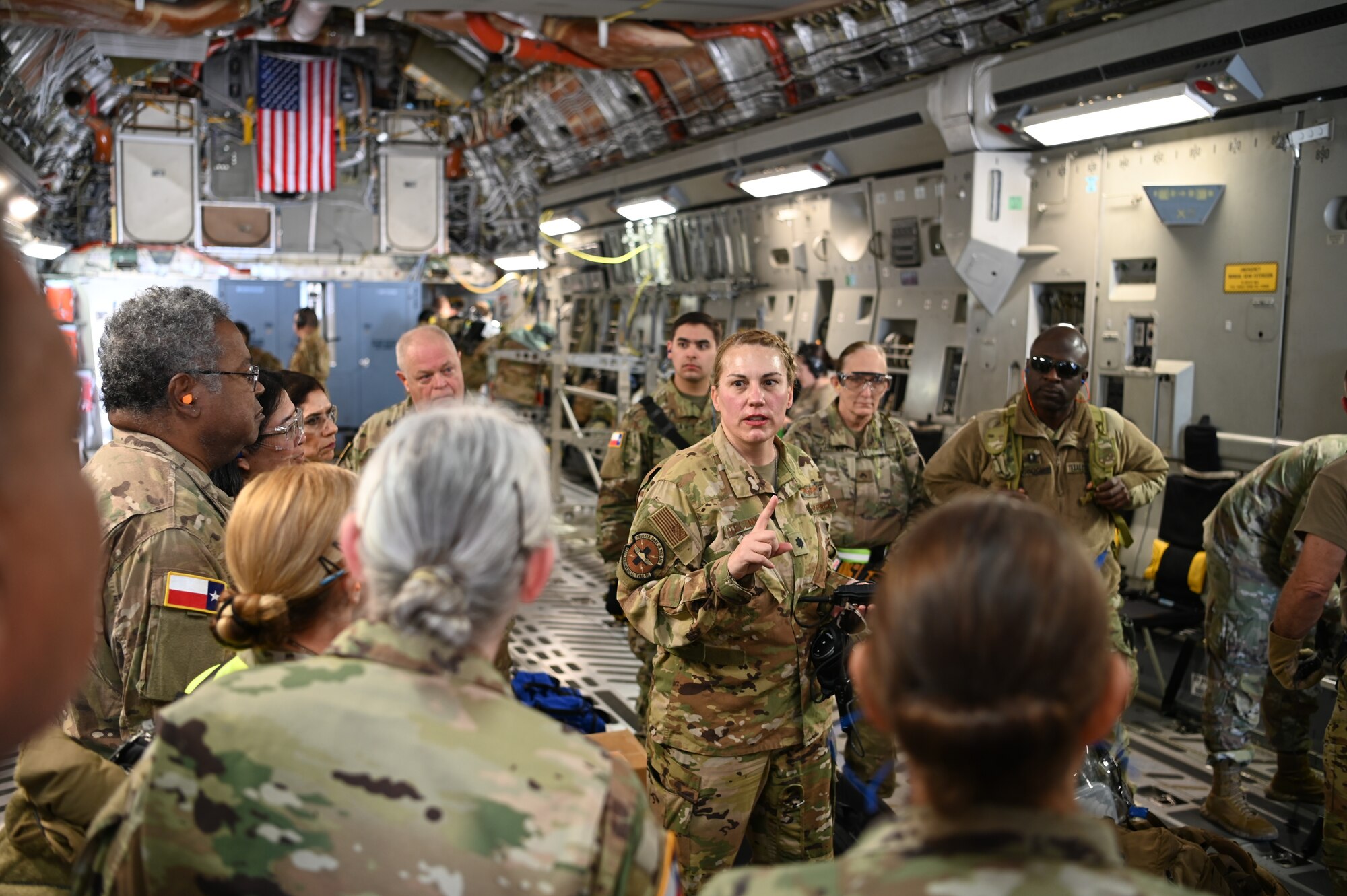 Lt. Col. Carolyn Stateczny, 433rd Aeromedical Evacuation Squadron chief of standards and evaluation, briefs a group of Texas State Guard medical personnel about the capabilities of an Air Force AES during a joint medical training event at Joint Base San Antonio-Lackland, Texas on Feb. 24, 2024.