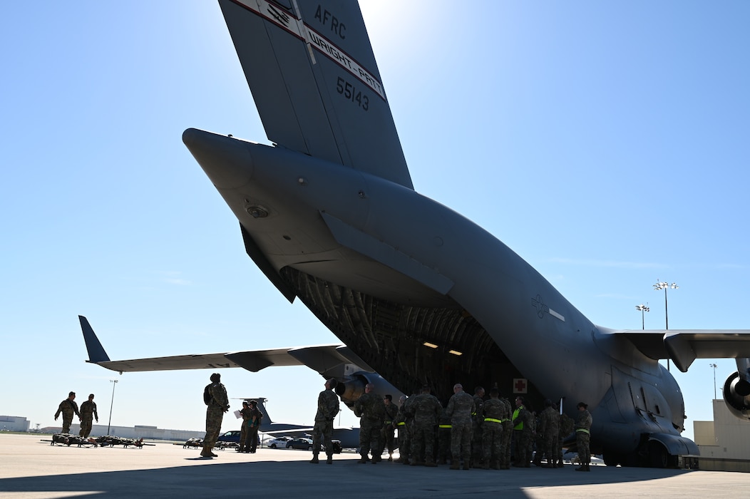 Texas State Guardsmen prepare to board a 445th Airlift Wing C-17 Globemaster as part of joint medical training with the 433rd Aeromedical Evacuation Squadron at Joint Base San Antonio-Lackland, Texas on Feb. 24, 2024.