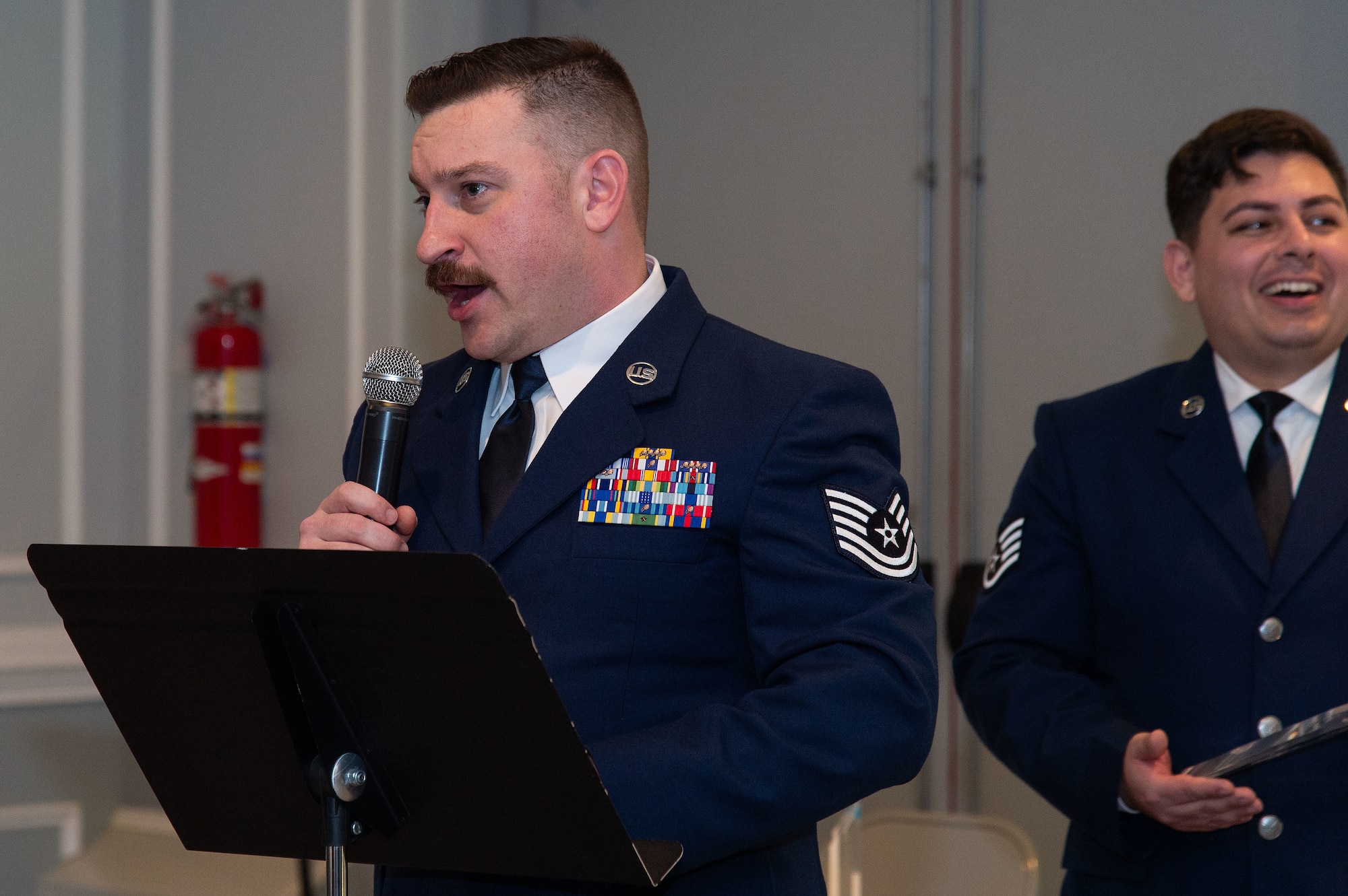U.S. Air Force Tech. Sgt. Michael Brockett, 436th Contracting Squadron contracting specialist and emcee for the 2023 436th Airlift Wing Annual Award Ceremony, speaks to attendees at the Hartly Volunteer Fire Company in Hartly, Delaware, Feb. 23, 2024. More than 275 commanders, first sergeants, supervisors, family members and friends came out to support the 47 nominees and five teams competing in their respective categories. (U.S. Air Force photo by Roland Balik)
