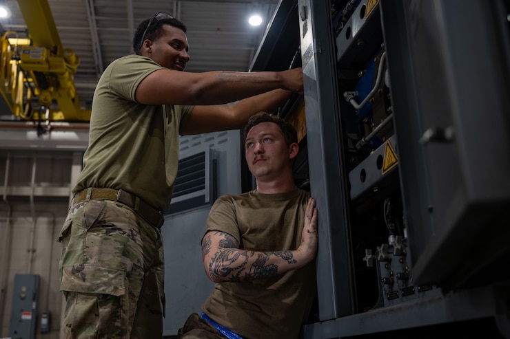 U.S. Air Force Senior Airman Alvin Murray, left, and Staff Sgt. Cory Watts, 1st Special Operations Maintenance Squadron Aerospace Ground Equipment mechanics, reconnect joints after replacing a defective high volume compressor in a Self Generating Nitrogen Servicing Cart at Hurlburt Field, Florida, Jan. 31, 2024.