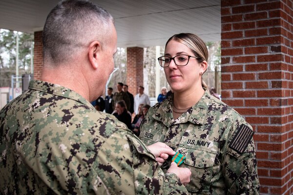 Navy Lt. Tess Bierl receives the Navy and Marine Corps Achievement Medal during an awards ceremony conducted Wednesday, February 28 aboard Naval Health Clinic Cherry Point.  Bierl served aboard the clinic as a Physician Assistant in the clinic’s Patient Centered Medical Home Port and Occupational Health departments.