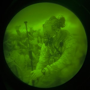 Airman sets up antenna at night