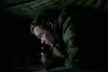 Airman uses communications equipment