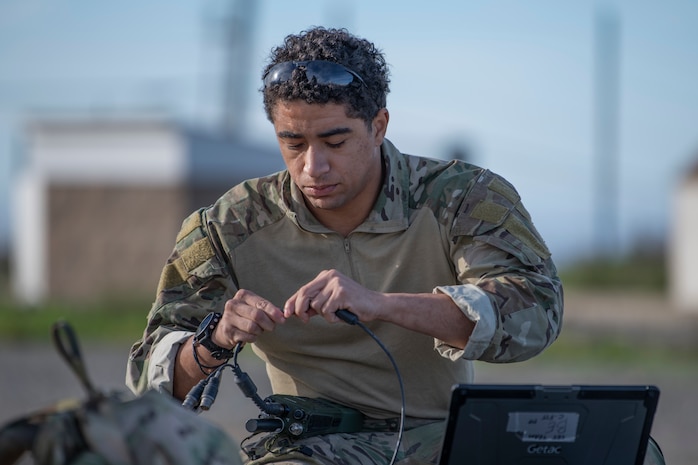 Airman sets up communications equipment