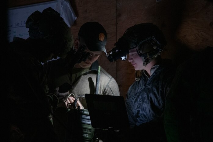 Airmen discuss operations at night