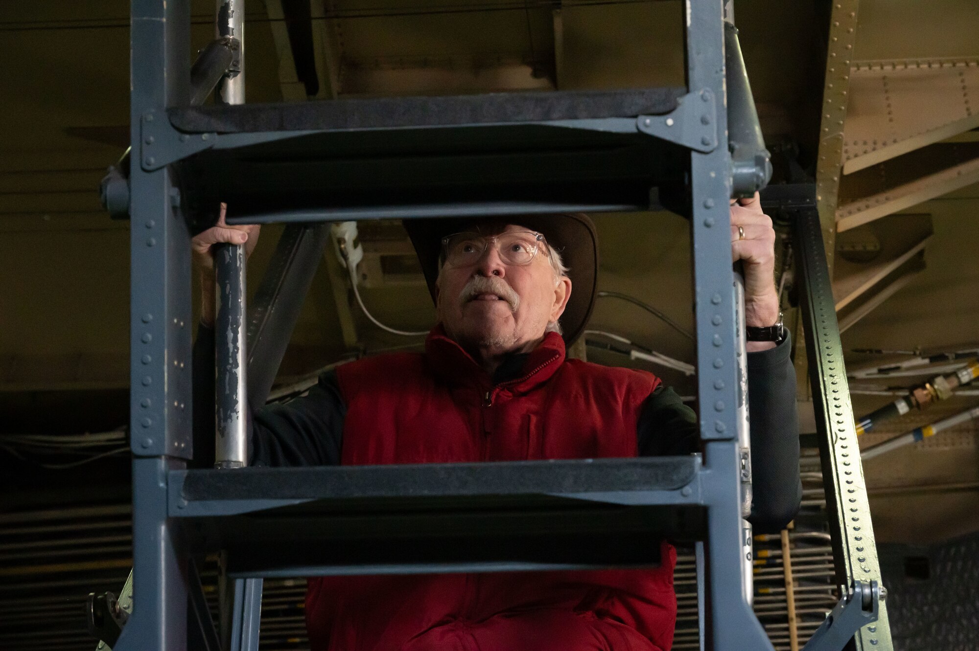 Joe Yacychyn, Dover Air Force Base Commander’s Council, climbs up the ladder of a C-5M Super Galaxy during the Operations Group honorary commanders tour at Dover AFB, Delaware, Feb 22, 2024. During the tour, the honorary commanders visited various units within the OG and interacted with Airmen to learn more about each unit’s role in the Dover AFB mission. (U.S. Air Force photo by Airman 1st Class Dieondiere Jefferies)