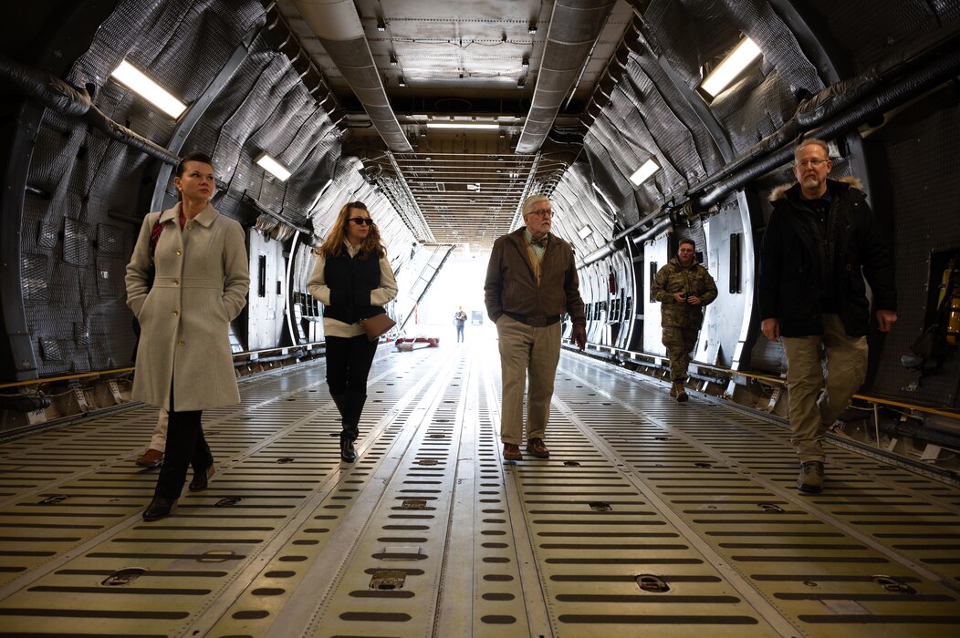 Team Dover honorary commanders walk inside the cargo bay of a C-5M Super Galaxy during the Operations Group honorary commanders tour at Dover Air Force Base, Delaware, Feb. 22, 2024. During the tour, the honorary commanders visited various units within the OG and interacted with Airmen to learn more about each unit’s role in the Dover AFB mission. (U.S. Air Force photo by Airman 1st Class Dieondiere Jefferies)