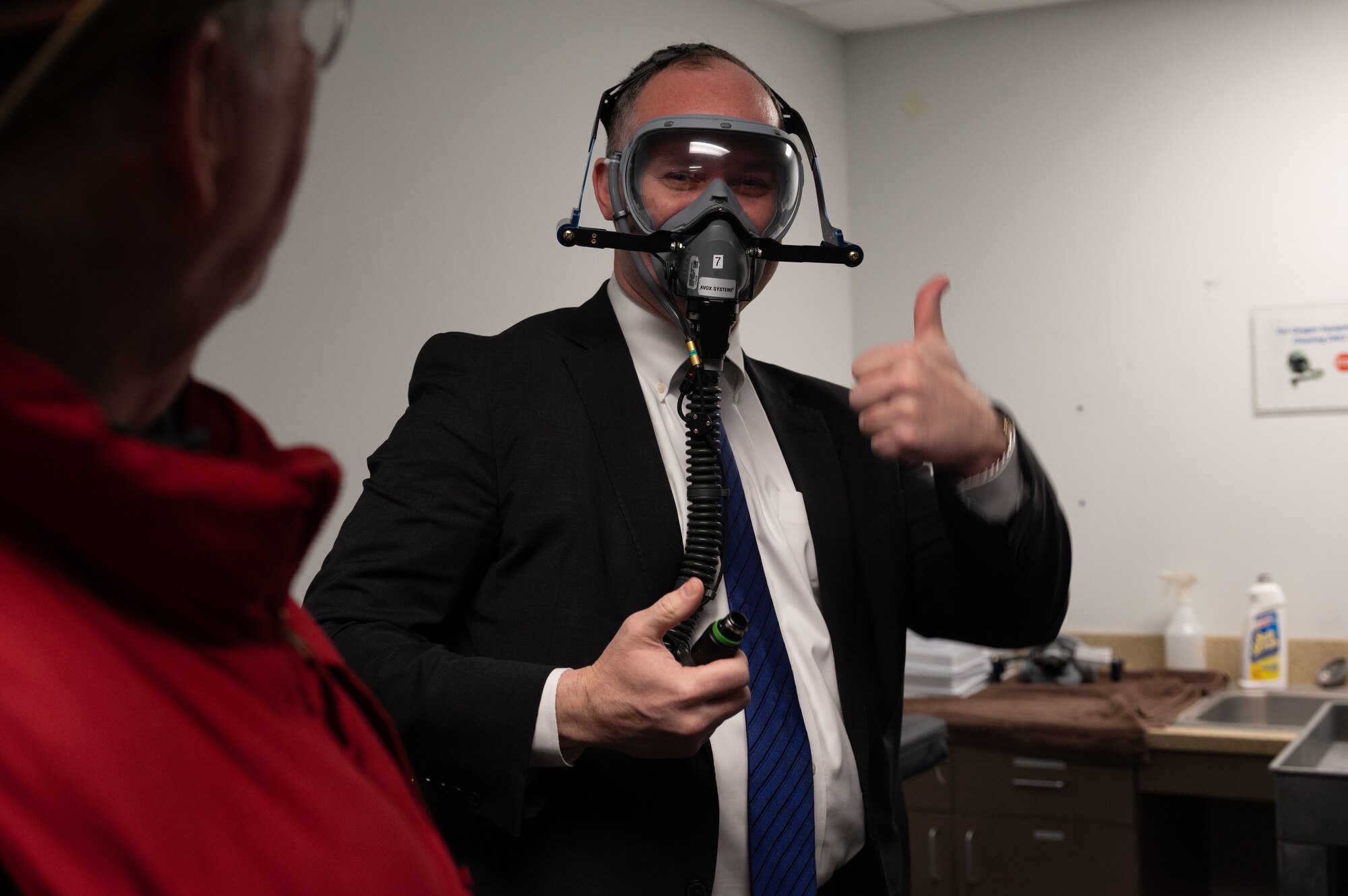 John Williams, 436th Wing Staff Agency Judge Advocate honorary commander, gives a thumbs up during a gas mask fit test at Dover Air Force Base, Delaware, Feb 22, 2024. A group of Team Dover honorary commanders visited various units during their tour of the Operations Group and interacted with Airmen to learn more about each unit’s role in the Dover AFB mission. (U.S. Air Force photo by Airman 1st Class Dieondiere Jefferies)