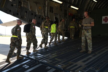 Chief Master Sgt. Michael Bolin, 433rd Aeromedical Evacuation Squadron, guides a group of Texas State Guardsmen aboard a C-17 Globemaster as part of a joint medical training event at Joint Base San Antonio-Lackland, Texas on Feb. 24, 2024.
