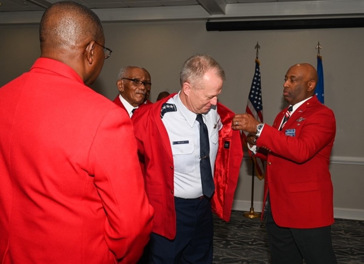 U.S. Air Force Gen. Mark Kelly, commander of Air Combat Command, receives the Red Tail Jacket.