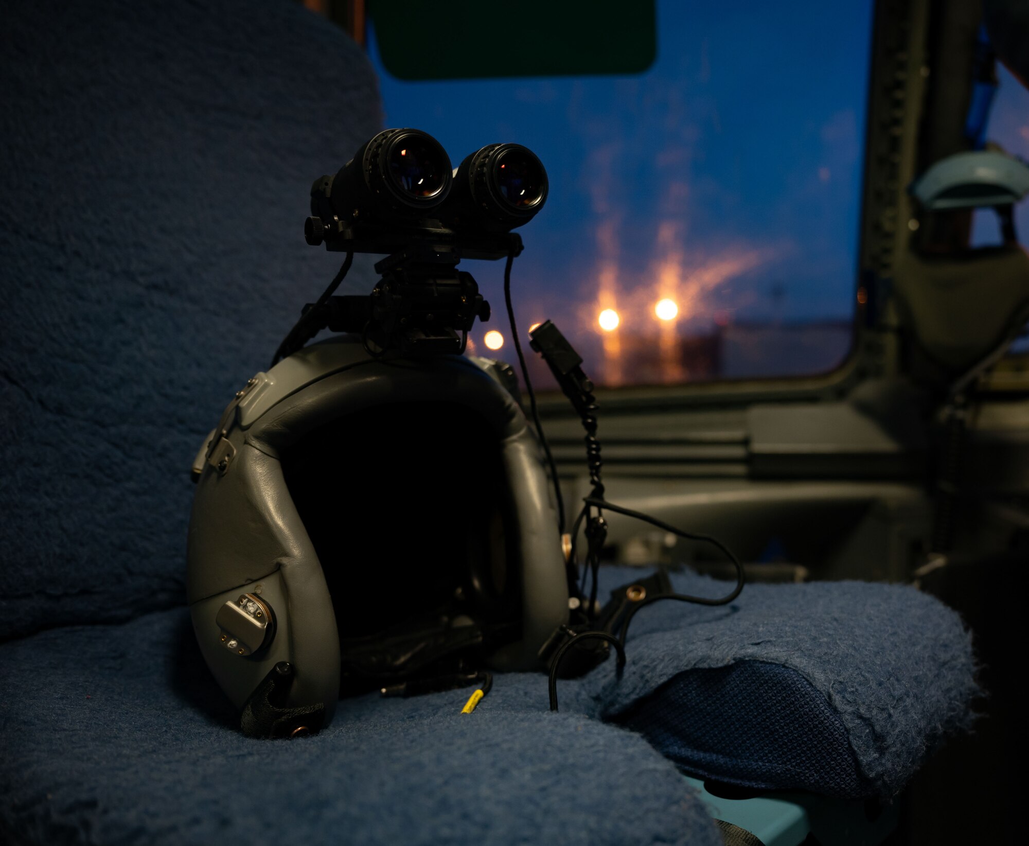 A flight helmet with night vision goggles is set in the seat of a C-17 Globemaster III prior to a local evening training sortie at Dover Air Force Base, Delaware, Feb. 26, 2024. The 3rd Airlift Squadron conducted local training in preparation to support worldwide airlift capabilities to include clandestine delivery, extraction and airdrop of special operations forces and equipment. (U.S. Air Force photo by Airman 1st Class Amanda Jett)