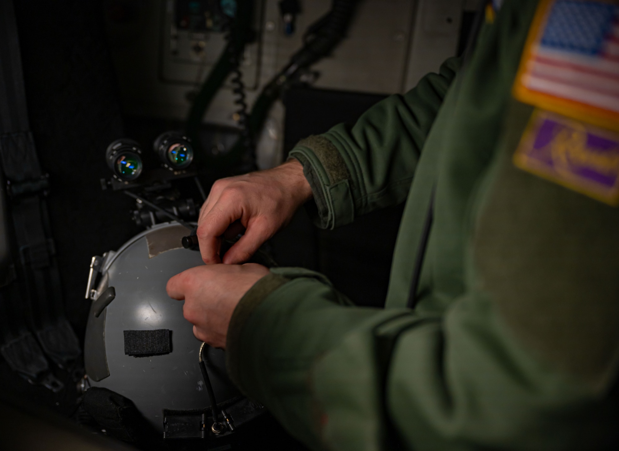 U.S. Air Force Senior Airman Charles Arnold, 3rd Airlift Squadron loadmaster, attaches night vision goggles to his helmet before a local evening training sortie at Dover Air Force Base, Delaware, Feb. 26, 2024. The 3rd AS conducted local training in preparation to support worldwide airlift capabilities to include clandestine delivery, extraction and airdrop of special operations forces and equipment. (U.S. Air Force photo by Airman 1st Class Amanda Jett)