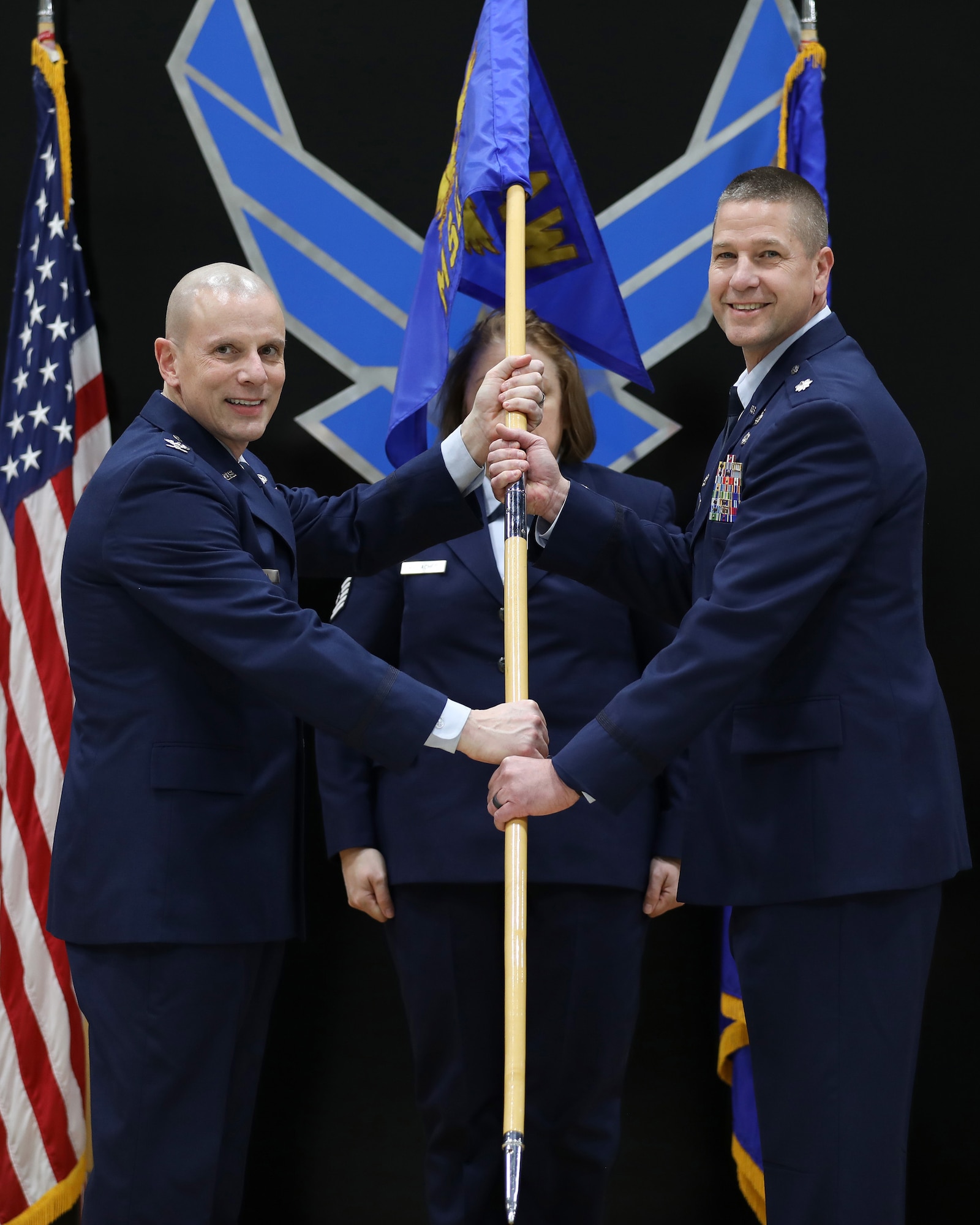 (left) Col. Matthew Muha, 445th Airlift Wing deputy commander, passes the guidon to Lt. Col. Robert Wengerter, incoming 445th Mission Support Group commander, during an assumption of command ceremony Feb. 3, 2024, at Wright-Patterson Air Force Base, Ohio. (U.S. Air Force photo/Senior Airman Angela Jackson)