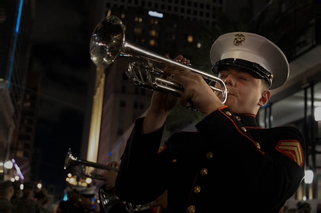 U.S. Marine Corps Cpl. Aden Taylor-Hardin, a musician with the 2d Marine Division (MARDIV) Band, performs a solo during the Krewe of Orpheus Parade in New Orleans, Louisiana, Feb. 12, 2024. The 2d MARDIV Band performed during Mardi Gras to support the local community through a joint effort with Marine Corps Forces Reserve Band to help bridge the gap between the Marine Corps and the people who support them. (U.S. Marine Corps photo by Lance Cpl. Kylie Lake)
