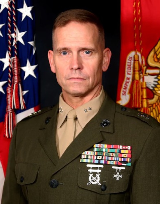 A light skinned man in a green Marine Corps uniform