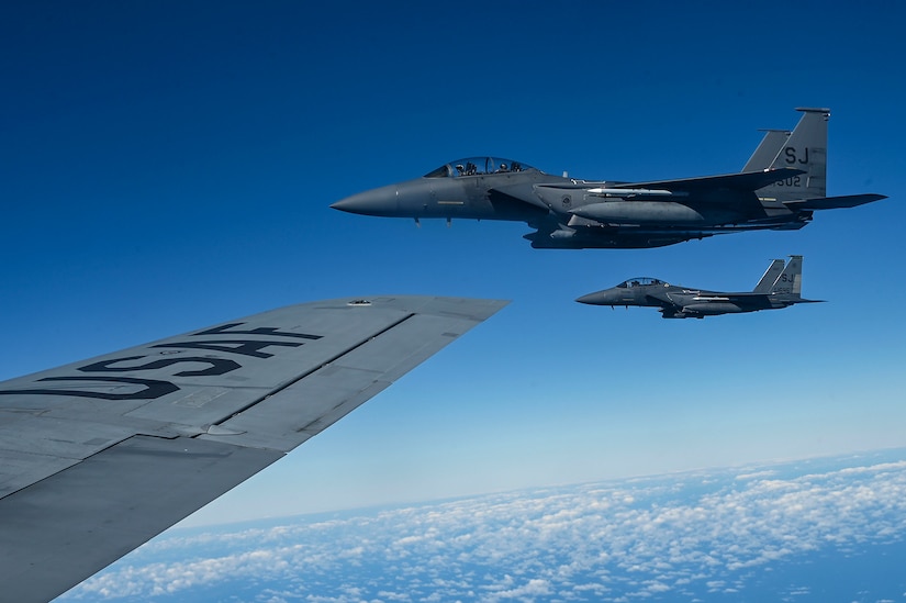 Fighter jets fly in formation.