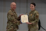 Col. David Christensen, 142nd Maintenance Group commander, presents 142nd Aircraft Maintenance Squadron Staff Sgt. Mara Fenwick with a meritorious service medal for acts of bravery Feb. 25, 2024, at Portland Air National Guard Base, Ore. Fenwick and a fellow Airman intervened when a truck went off the road in Eastern Oregon in May 2023.