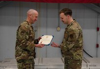 Col. David Christensen, 142nd Maintenance Group commander, presents 142nd Aircraft Maintenance Squadron Senior Airman Bailey Buck with a meritorious service medal for acts of bravery Feb. 25, 2024, at Portland Air National Guard Base, Ore. Fenwick and a fellow Airman intervened when a truck went off the road in Eastern Oregon in May 2023.