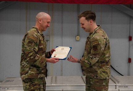 Col. David Christensen, 142nd Maintenance Group commander, presents 142nd Aircraft Maintenance Squadron Senior Airman Bailey Buck with a meritorious service medal for acts of bravery Feb. 25, 2024, at Portland Air National Guard Base, Ore. Fenwick and a fellow Airman intervened when a truck went off the road in Eastern Oregon in May 2023.