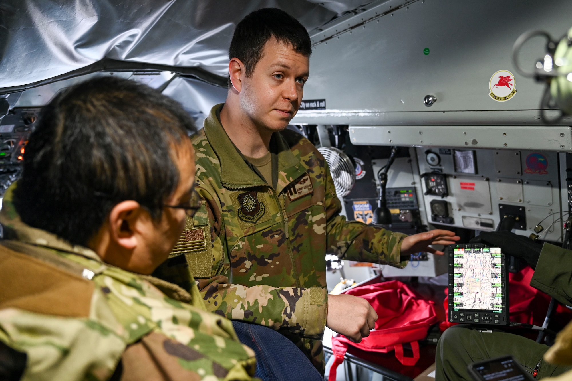 An Airman instructs Airmen about the Real Time information in Cockpit system