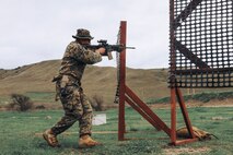 U.S. Marine Corps Sgt. Robin Alejandro Mendoza, left, a chief combat marksmanship coaches course instructor with Weapons and Field Training Battalion and a member of the Edson Range shooting team, engages a target during an action rifle stage at the Marine Corps Marksmanship Competition West at Marine Corps Base Camp Pendleton, California, Feb. 23, 2024. Mendoza is a native of Auburn, Washington. The MCMC West was held in conjunction with several other competitions around the Marine Corps to find the top 10 percent of shooters who will go on to compete in the national tournament in Quantico, Virginia for a place on the Marine Corps Shooting Team. (U.S. Marine Corps photo by Cpl. Alexander O. Devereux)
