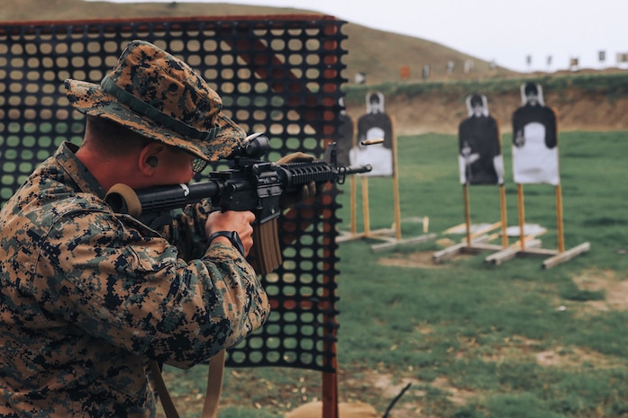 U.S. Marine Corps Staff Sgt. Loren Smith, chief academic instructor, Support Training Battalion, Marine Corps Recruit Depot San Diego and a member of the Edson Range shooting team, engages a target during an action rifle stage at the Marine Corps Marksmanship Competition West at Marine Corps Base Camp Pendleton, California, Feb. 23, 2024. Smith is a native of Cascade, Idaho. The MCMC West was held in conjunction with several other competitions around the Marine Corps to find the top 10 percent of shooters who will go on to compete in the national tournament in Quantico, Virginia for a place on the Marine Corps Shooting Team. (U.S. Marine Corps photo by Cpl. Alexander O. Devereux)