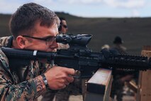 U.S. Marine Corps Sgt. Justin Garvey-Lease, a chief combat marksmanship coaches course instructor with Weapons and Field Training Battalion and a member of the Edson Range shooting team, engages ‘unknown distance’ targets during a long-bay rifle stage at the Marine Corps Marksmanship Competition West at Marine Corps Base Camp Pendleton, California, Feb. 23, 2024. Garvey is a native of Omaha, Nebraska. The MCMC West was held in conjunction with several other competitions around the Marine Corps to find the top 10 percent of shooters who will go on to compete in the national tournament in Quantico, Virginia for a place on the Marine Corps Shooting Team. (U.S. Marine Corps photo by Cpl. Alexander O. Devereux)