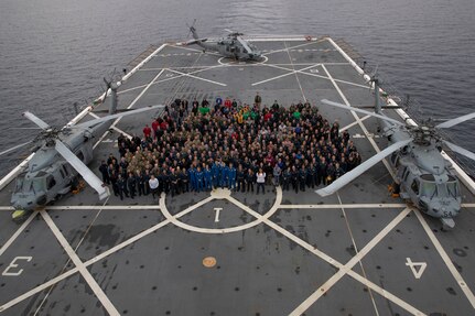 Department of Defense personnel from USS San Diego (LPD 22), Helicopter Sea Combat Squadron 23, Explosive Ordnance Disposal Expeditionary Mobile Unit 1, First Air Force, Detachment 3, and 45th Space Launch Delta Weather Squadron pose for a photo with NASA personnel and the crew of Artemis II on the ship’s flight deck while underway for NASA’s Underway Recovery Test 11, Feb. 26, 2024. In preparation for NASA’s Artemis II crewed mission, which will send four astronauts in Orion beyond the Moon, NASA and the Department of Defense will conduct a series of tests to demonstrate and evaluate the processes, procedures, and hardware used in recovery operations for crewed lunar missions. The U.S. Navy has many unique capabilities that make it an ideal partner to support NASA, including its amphibious ships with the ability to embark helicopters, launch and recover small boats, three-dimensional air search radar and advanced medical facilities. (U.S. Navy photo by Mass Communication Specialist 2nd Class Olivia Rucker)